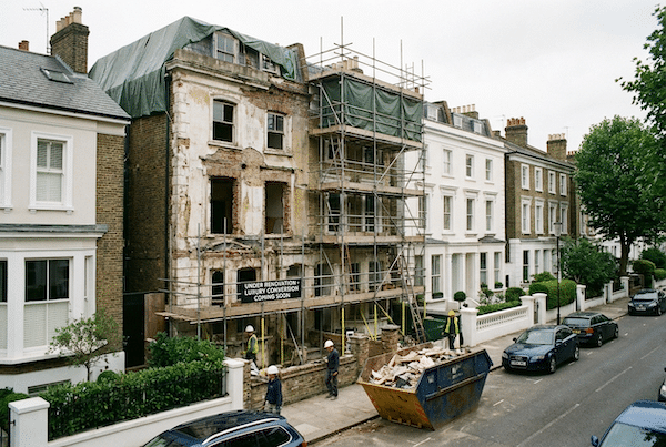 London property under renovation - scaffolding and skip